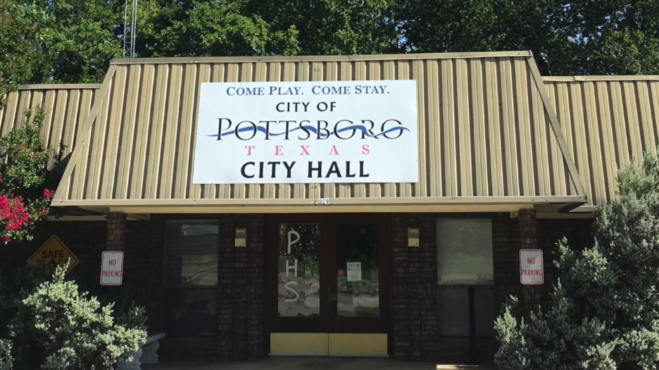 Pottsboro City Hall and its entrance sign